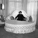 Eden Hartford Marx, wife of Groucho, in her white and gold bedroom and bathroom in Beverly Hills, March 1958. The white and gold motif is carried out in both these room, including bed and other furnishings and the equipment in the bathroom. Pooch's name is DeSoto," a family pet. ()
